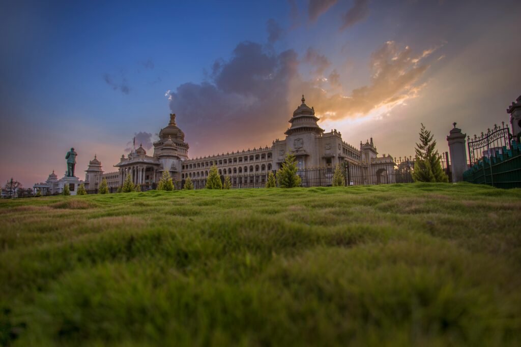 Capture of Vidhana Soudha in Bengaluru with a vibrant sunset sky, showcasing beautiful architecture.