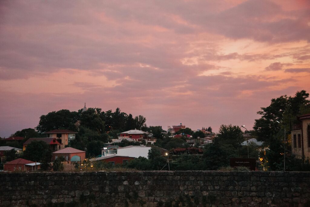 Charming townscape with colorful houses under a stunning sunset sky.
